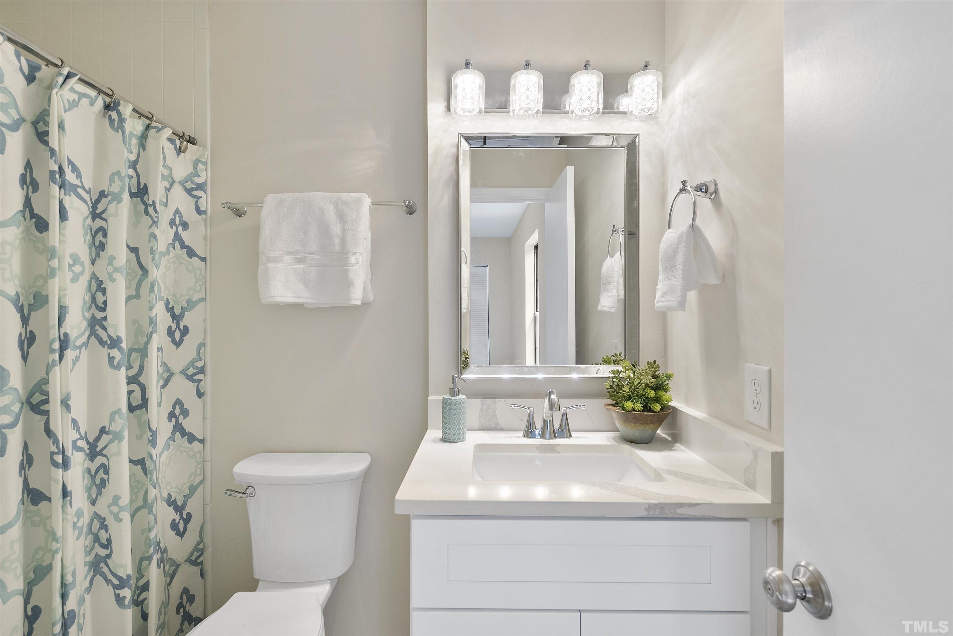 7779 Falcon Rest Circle Raleigh, NC 27615 - Photo 26 of 28 a bathroom with a sink and a mirror