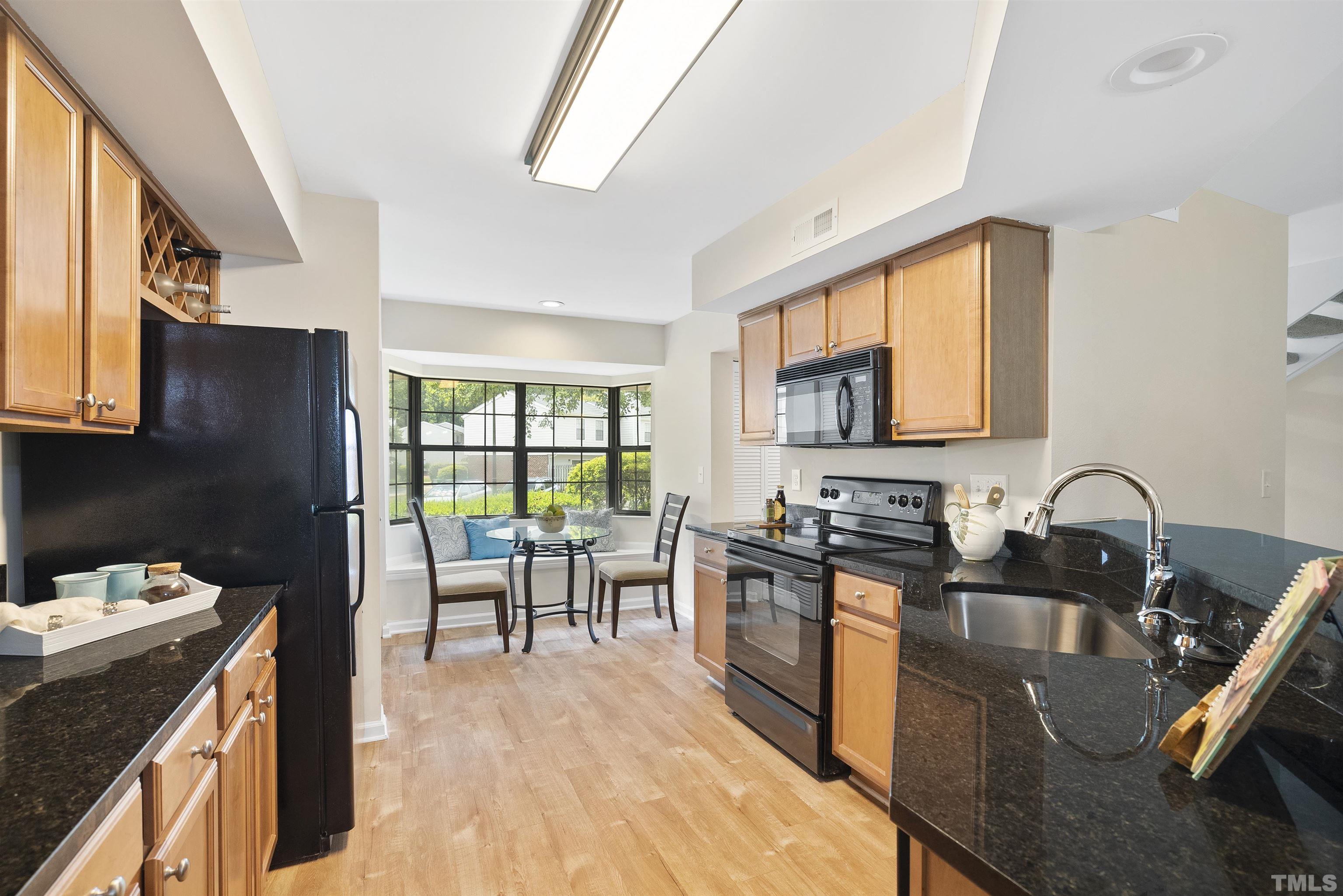 7779 Falcon Rest Circle Raleigh, NC 27615 - Photo 7 of 28 a kitchen with a sink stove top oven and refrigerator