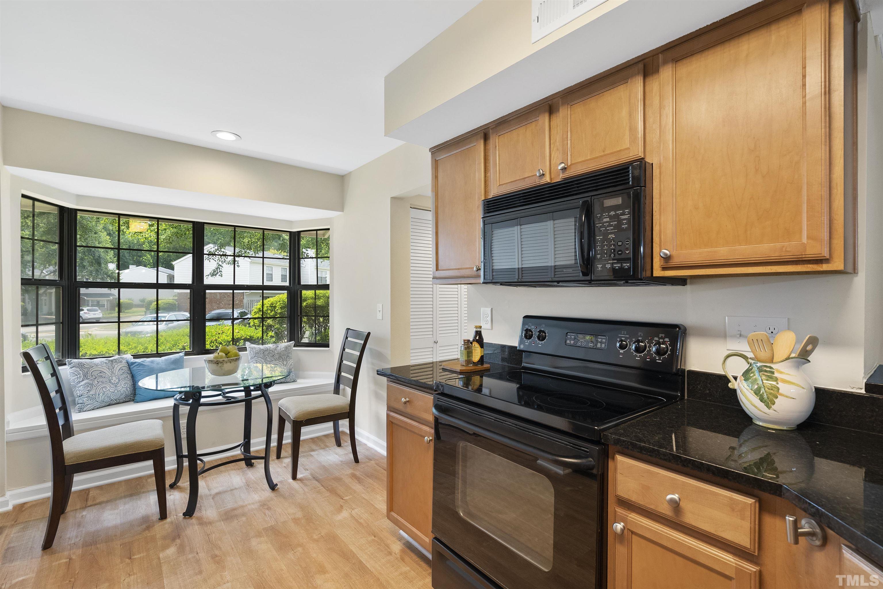 7779 Falcon Rest Circle Raleigh, NC 27615 - Photo 8 of 28 a kitchen with a stove and a microwave
