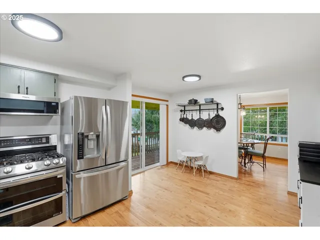 a kitchen with stainless steel appliances granite countertop a refrigerator and a stove top oven