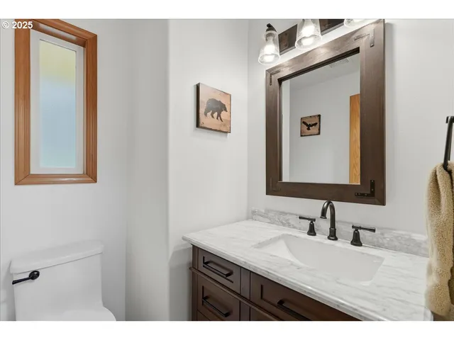 a bathroom with a granite countertop sink a mirror and a