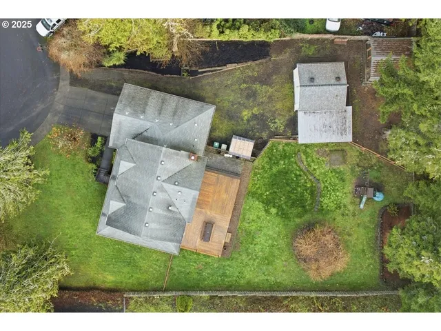 an aerial view of a house with a yard basket ball court and outdoor seating