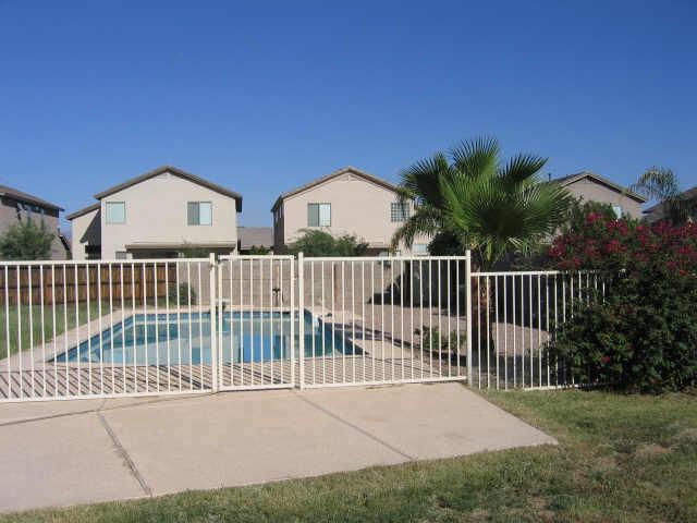 4019 East St John Road Phoenix, AZ 85032 - Photo 3 of 6 a view of a house with a small yard and fence