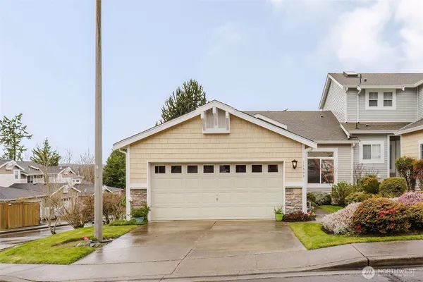 a view of a house with a yard and plants