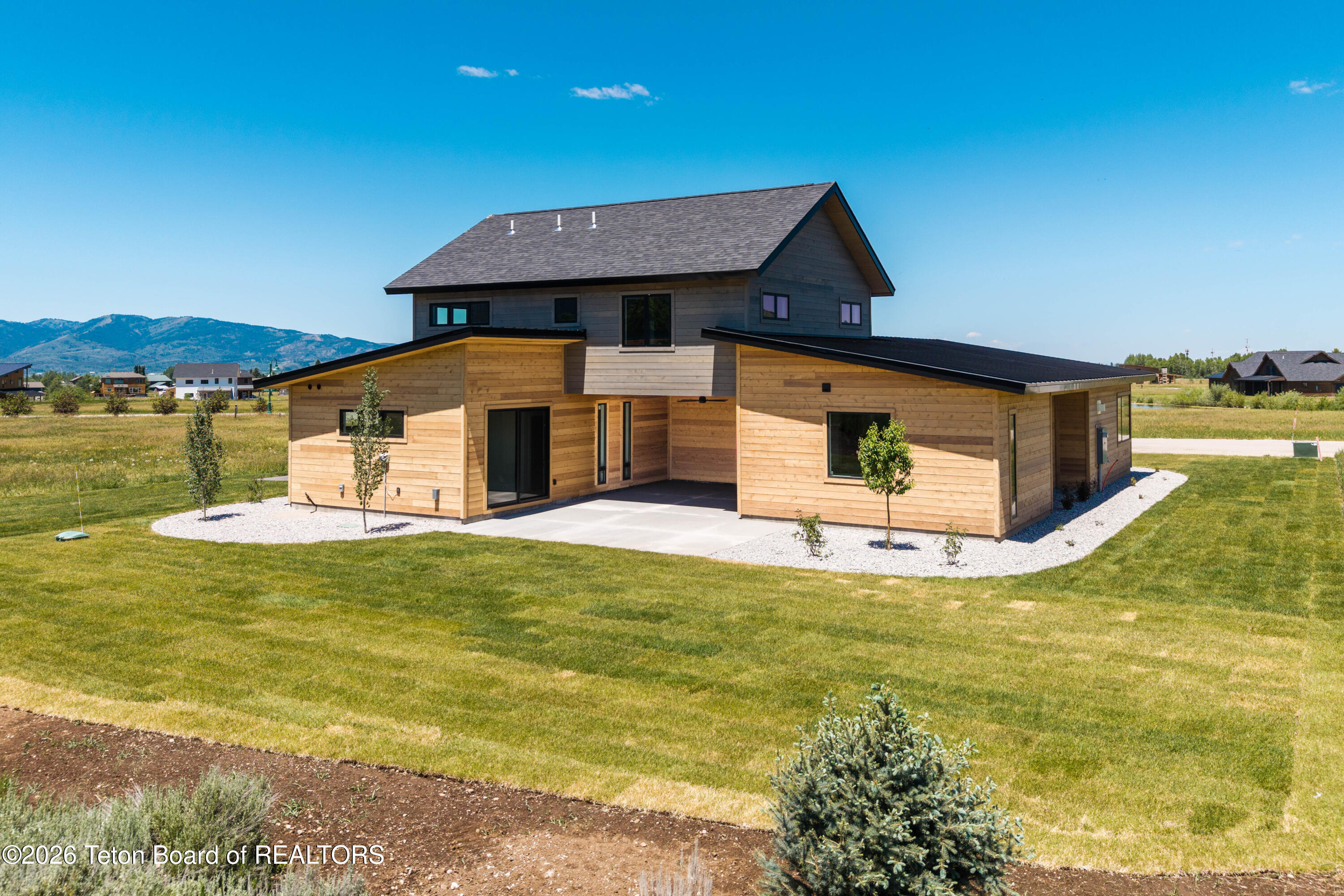 9491 Timberline Loop Victor, ID 83455 - Photo 7 of 19 Landscaped with covered patio