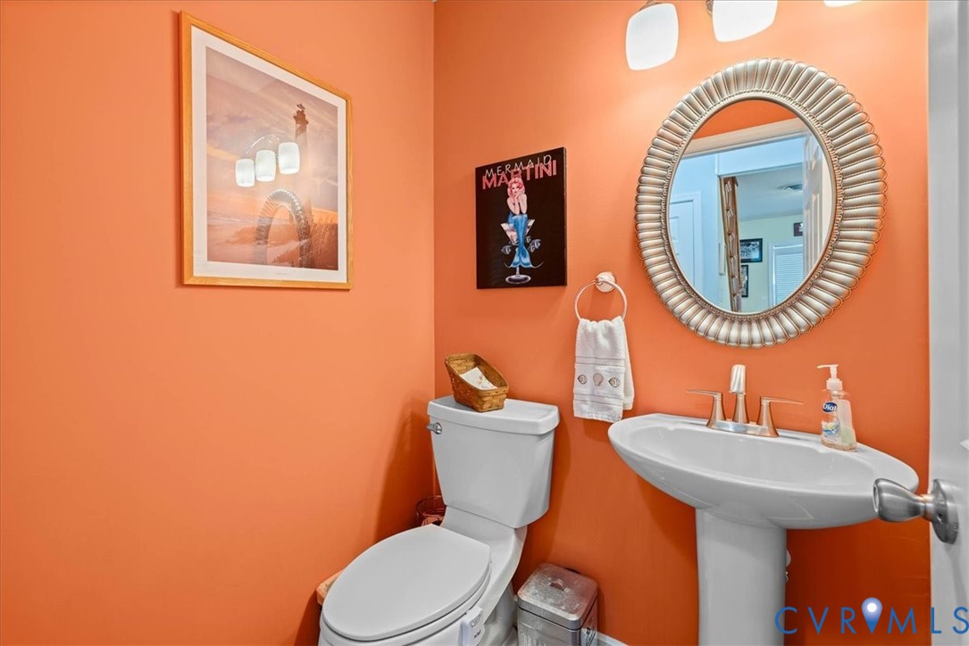 683 Villa Road Claremont, VA 23881 - Photo 15 of 28 a bathroom with a toilet a sink and a mirror
