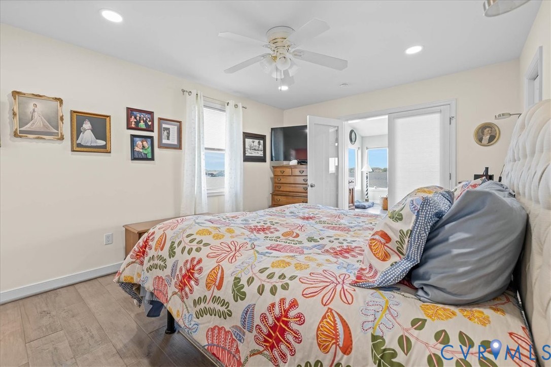 683 Villa Road Claremont, VA 23881 - Photo 20 of 28 a bedroom with a large bed and a chandelier