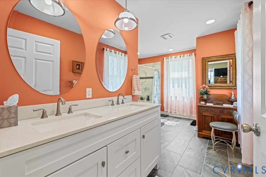 683 Villa Road Claremont, VA 23881 - Photo 22 of 28 a bathroom with a sink mirror and a shower