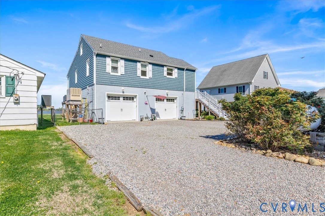 683 Villa Road Claremont, VA 23881 - Photo 5 of 28 a front view of a house with a yard and garage