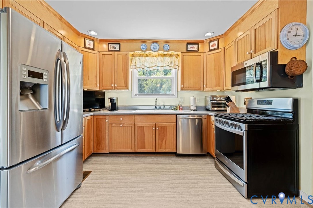683 Villa Road Claremont, VA 23881 - Photo 10 of 28 a kitchen with stainless steel appliances granite countertop a refrigerator a stove a sink and a microwave