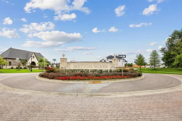 a view of a brick house with potted plants