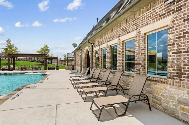 a view of a patio with a table chairs and a large tree