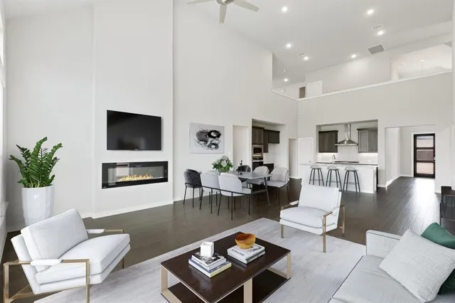 a living room with furniture a rug and a flat screen tv