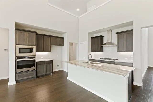 a kitchen with a sink stove and cabinets