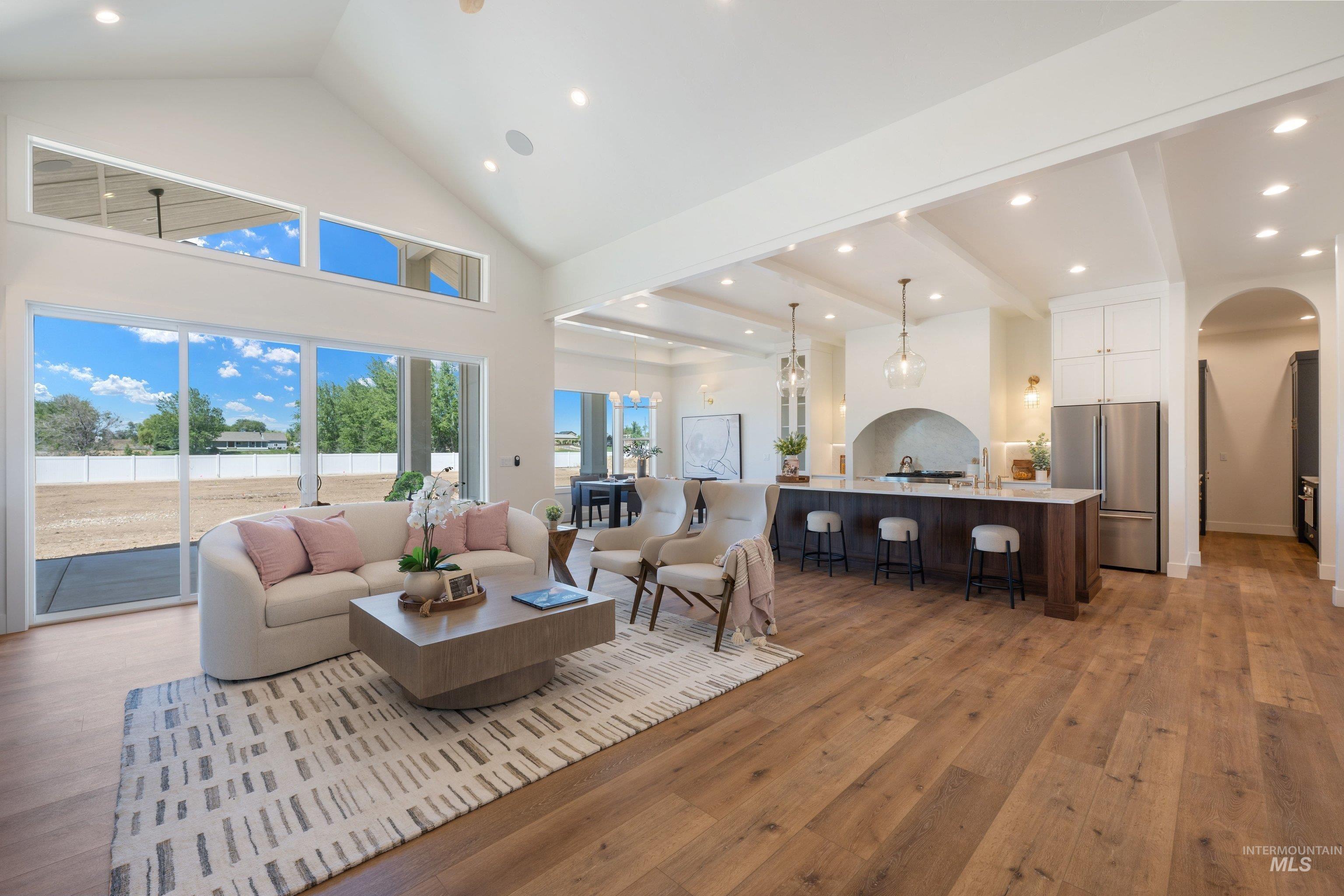 24821 Ardmore Court Caldwell, ID 83607 - Photo 13 of 43 Expansive living area with vaulted ceilings and wood-finish flooring