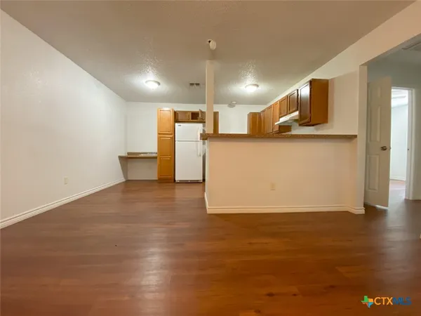 a view of a kitchen with wooden floor