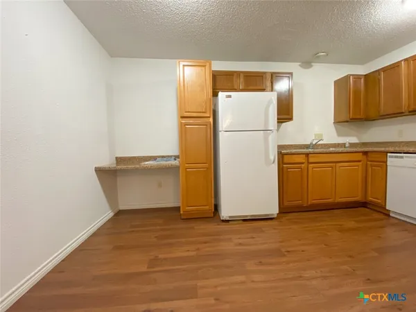a kitchen with stainless steel appliances a refrigerator and a sink