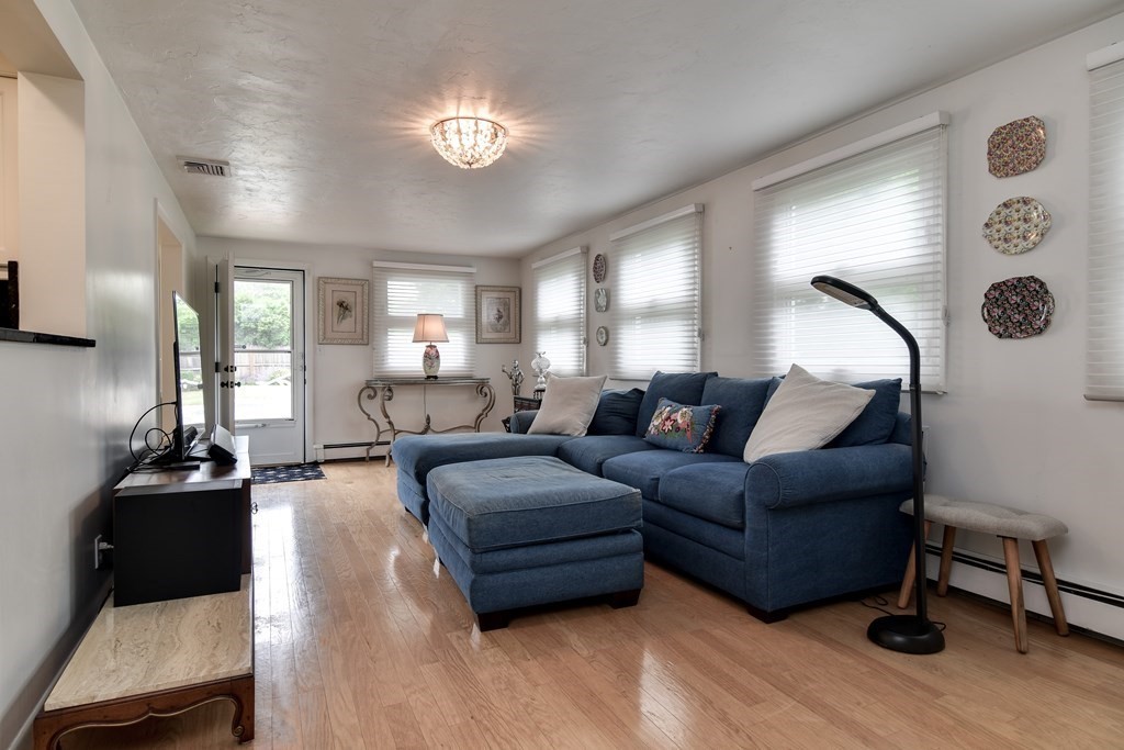 41 Lohnes Road Framingham, MA 01701 - Photo 14 of 36 a living room with furniture and a chandelier
