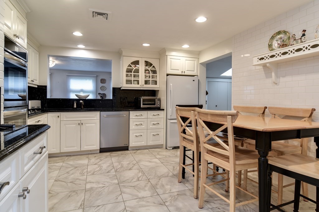 41 Lohnes Road Framingham, MA 01701 - Photo 6 of 36 a kitchen with stainless steel appliances kitchen island granite countertop a sink and cabinets