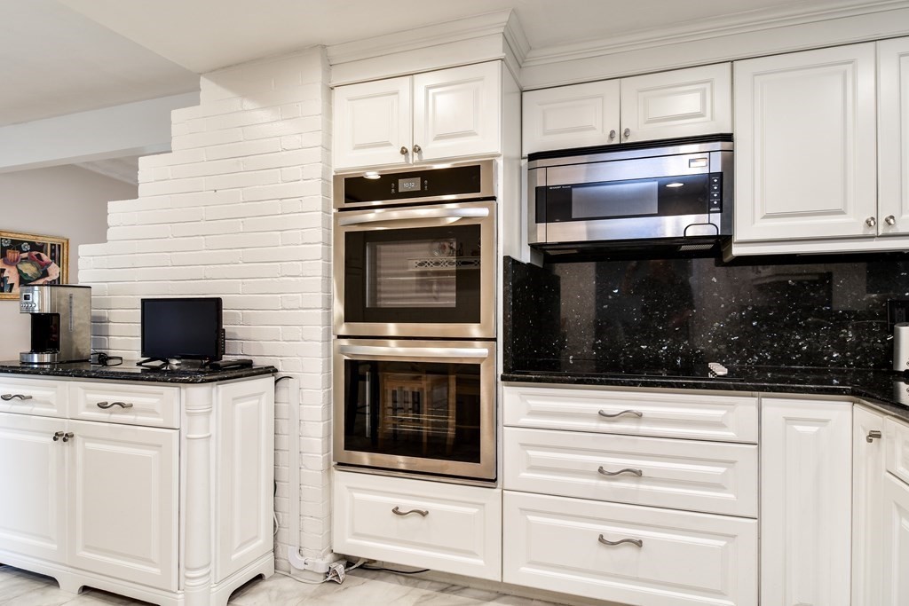 41 Lohnes Road Framingham, MA 01701 - Photo 8 of 36 a kitchen with granite countertop white cabinets stainless steel appliances and sink