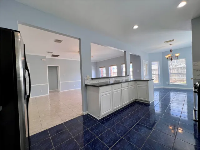 a kitchen with stainless steel appliances granite countertop a sink counter space cabinets and a large window