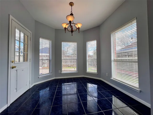 a view of entryway with wooden floor and windows