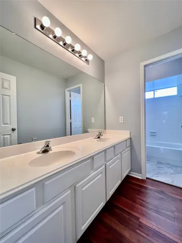 a view of a room with wooden floor and windows