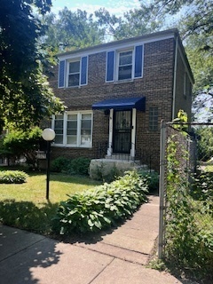 1329 East 89th Place Chicago, IL 60619 - Photo 1 of 11 a view of a brick house with a yard and plants