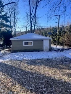 a view of house with backyard and trees