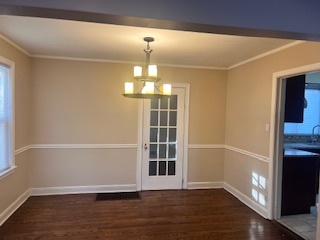 1329 East 89th Place Chicago, IL 60619 - Photo 3 of 11 a view of an empty room with wooden floor and a window
