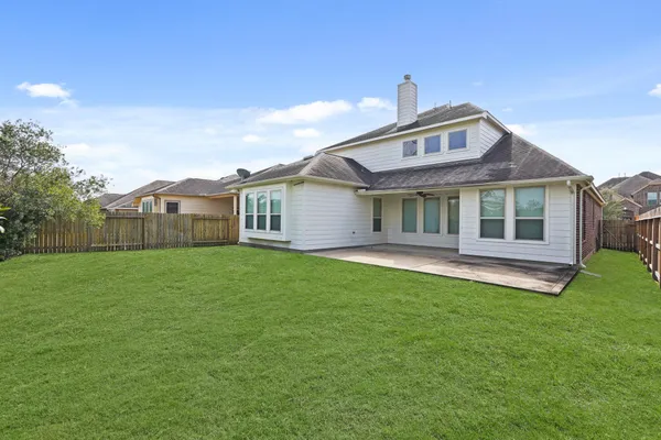 a front view of a house with a garden and yard