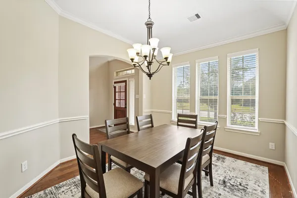 a view of a dining room with furniture and chandelier
