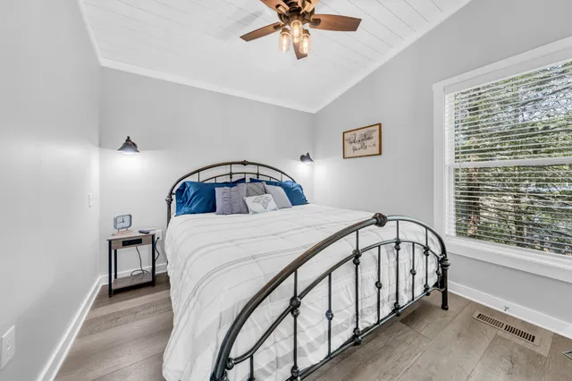 a bedroom with a bed and a window