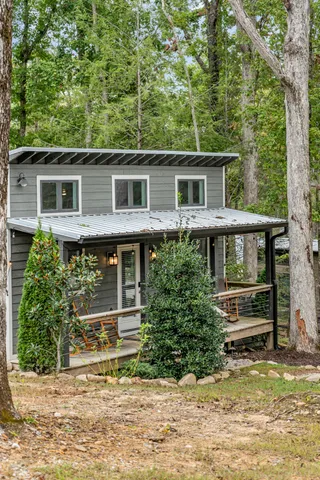 a wooden bench sitting in the middle of a yard