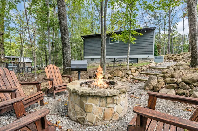 a front view of a house with a yard and fountain