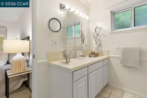 a bathroom with a sink vanity toilet and a mirror