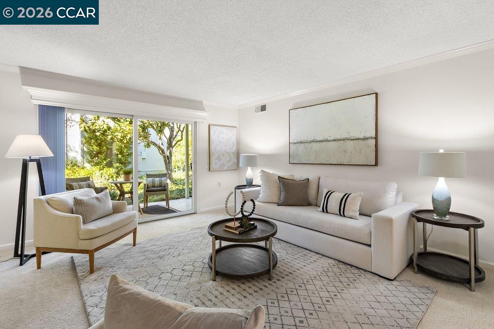 2057 Golden Rain Road, Unit 8 Walnut Creek, CA 94595 - Photo 44 of 60 a living room with furniture and a large window
