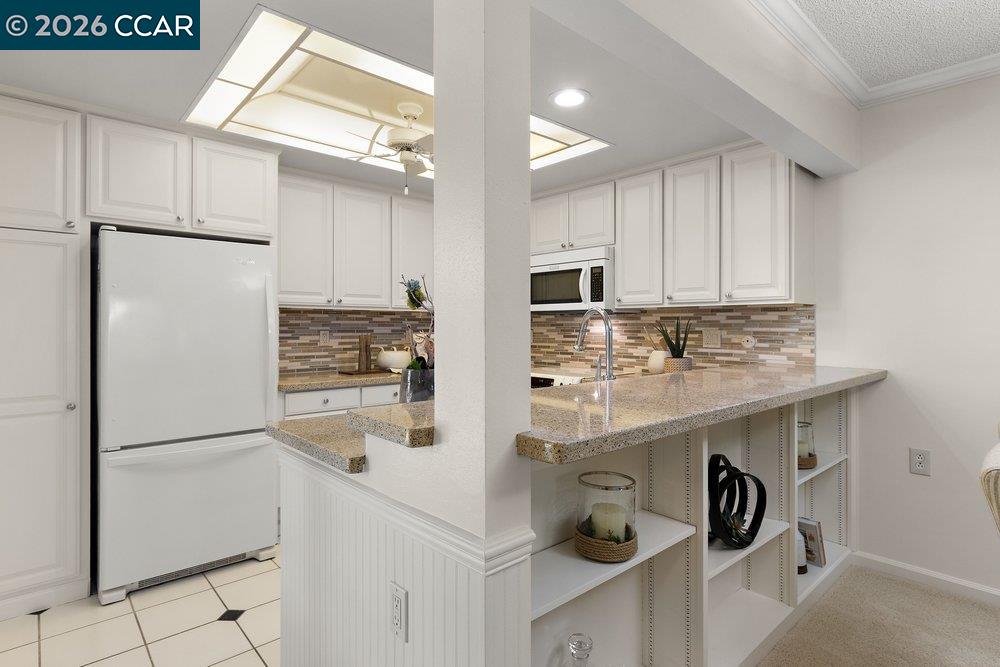 2057 Golden Rain Road, Unit 8 Walnut Creek, CA 94595 - Photo 50 of 60 a kitchen with kitchen island a sink appliances and cabinets