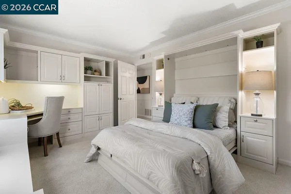 a bedroom with a bed and a refrigerator