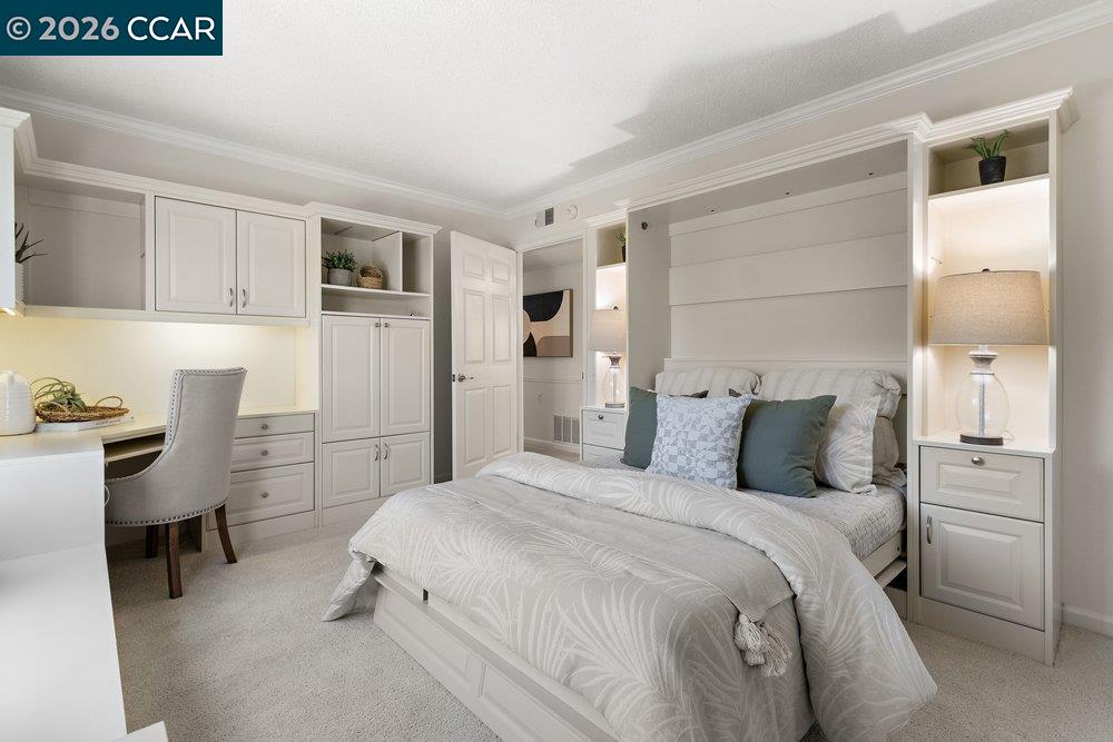 2057 Golden Rain Road, Unit 8 Walnut Creek, CA 94595 - Photo 5 of 60 a bedroom with a bed and a refrigerator