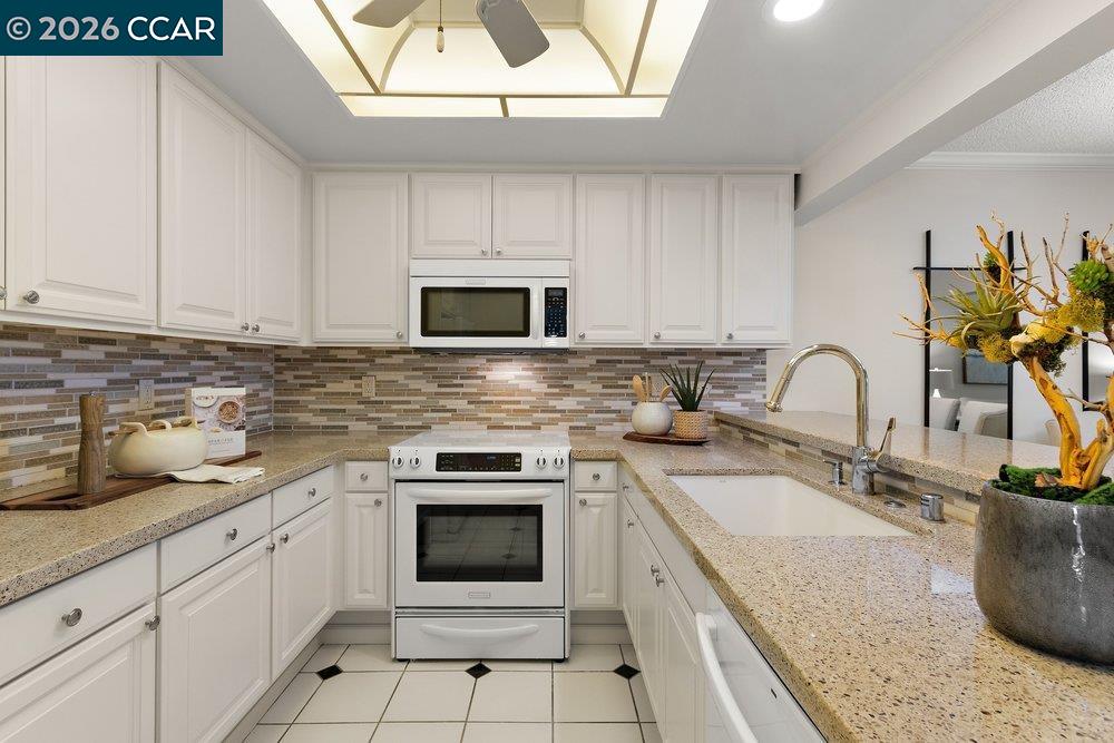 2057 Golden Rain Road, Unit 8 Walnut Creek, CA 94595 - Photo 51 of 60 a kitchen with sink a stove and cabinets