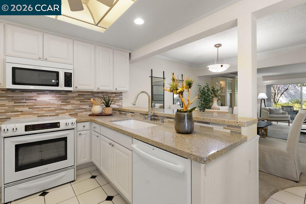 2057 Golden Rain Road, Unit 8 Walnut Creek, CA 94595 - Photo 52 of 60 a kitchen with sink a stove and microwave