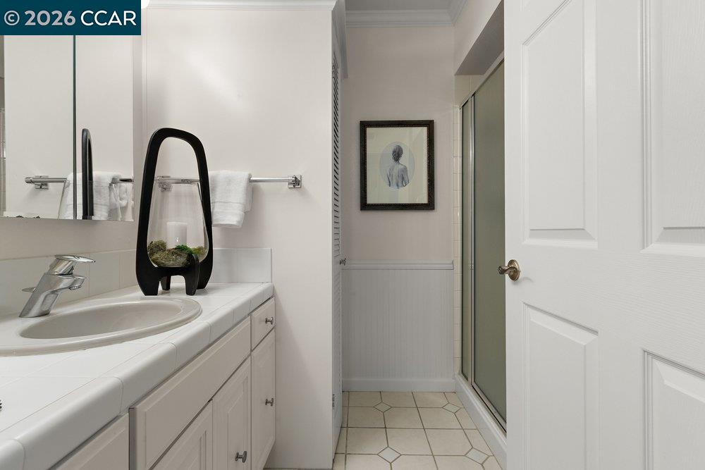 2057 Golden Rain Road, Unit 8 Walnut Creek, CA 94595 - Photo 6 of 60 a bathroom with a sink and a mirror