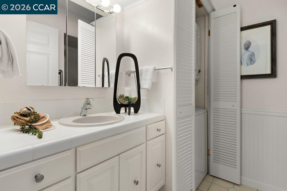 2057 Golden Rain Road, Unit 8 Walnut Creek, CA 94595 - Photo 7 of 60 a bathroom with a sink and a mirror