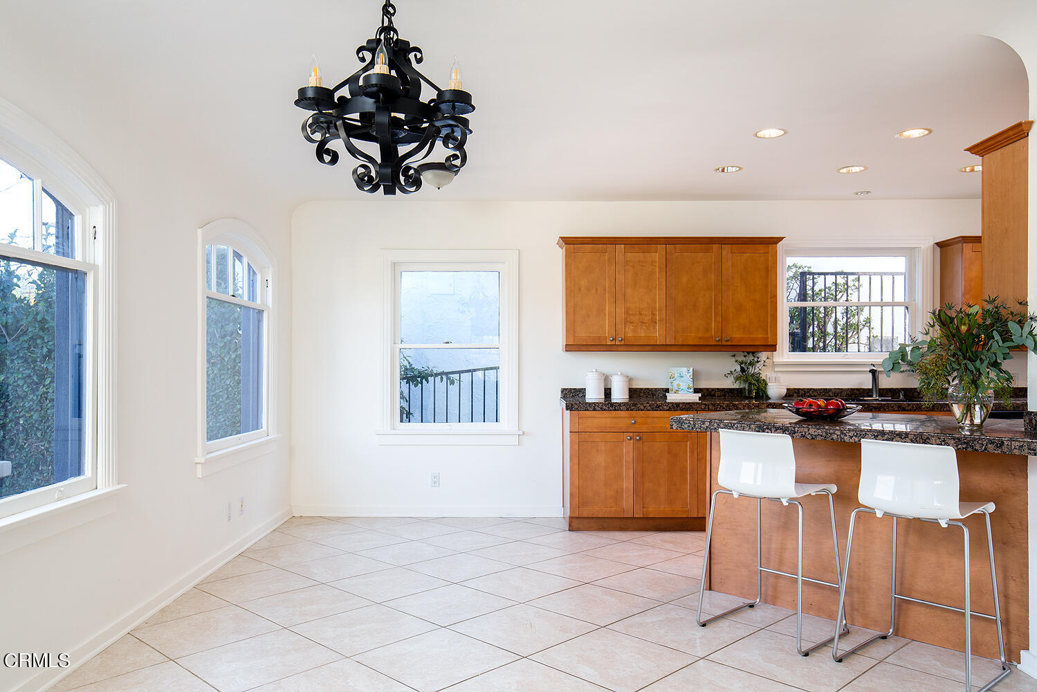 1273 Crescent Drive Glendale, CA 91205 - Photo 11 of 34 a kitchen with granite countertop a stove a sink dishwasher a dining table and chairs with wooden floor