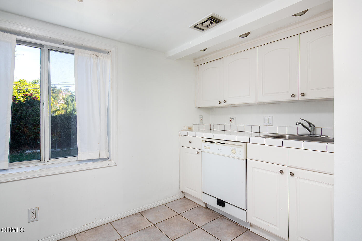 1273 Crescent Drive Glendale, CA 91205 - Photo 31 of 34 a kitchen with granite countertop white cabinets and window