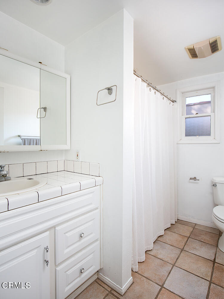 1273 Crescent Drive Glendale, CA 91205 - Photo 34 of 34 a bathroom with a sink a toilet and mirror