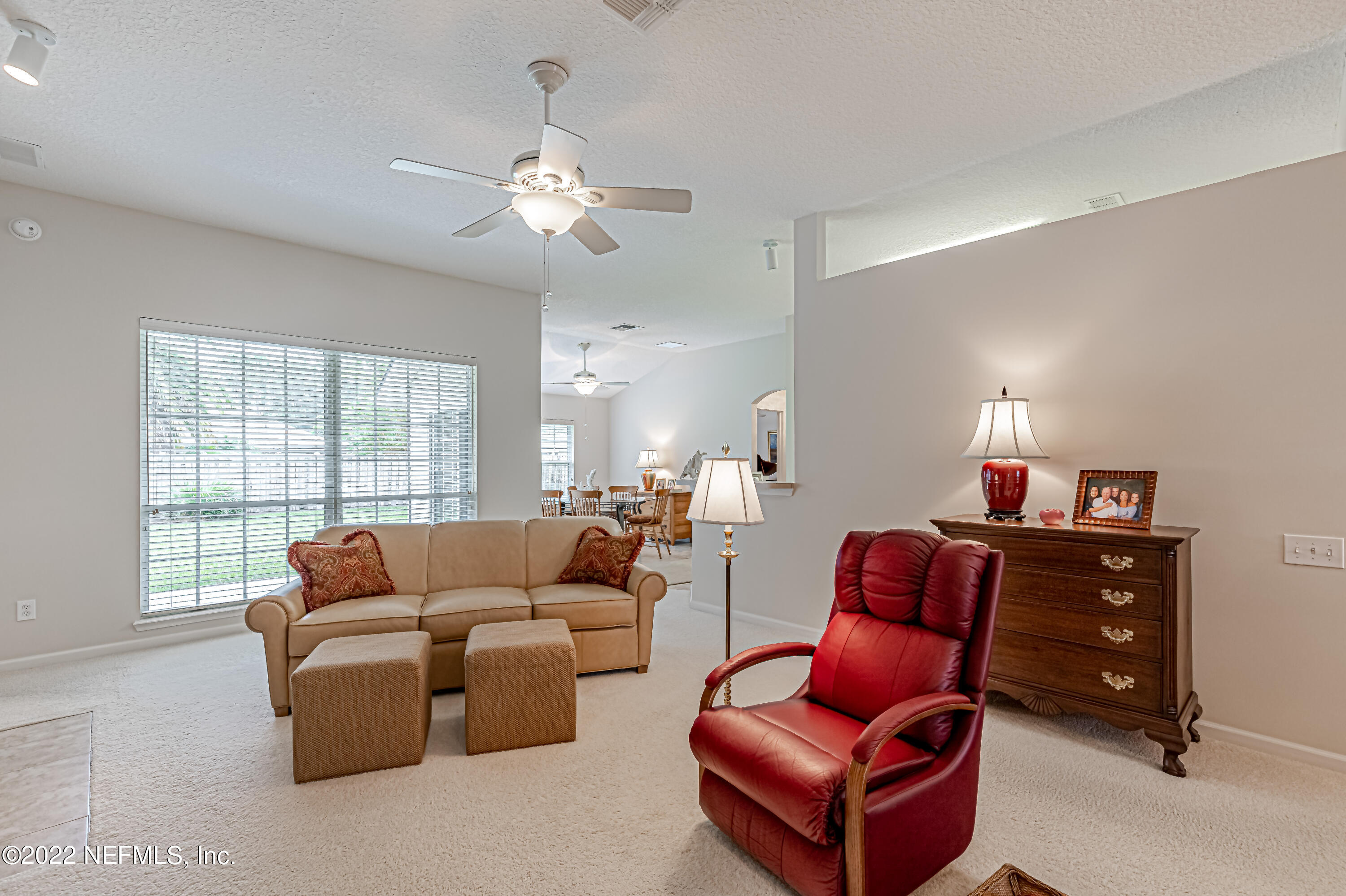 124 Dragonfly Drive Jacksonville, FL 32259 - Photo 12 of 40 a living room with furniture a large window and a chandelier