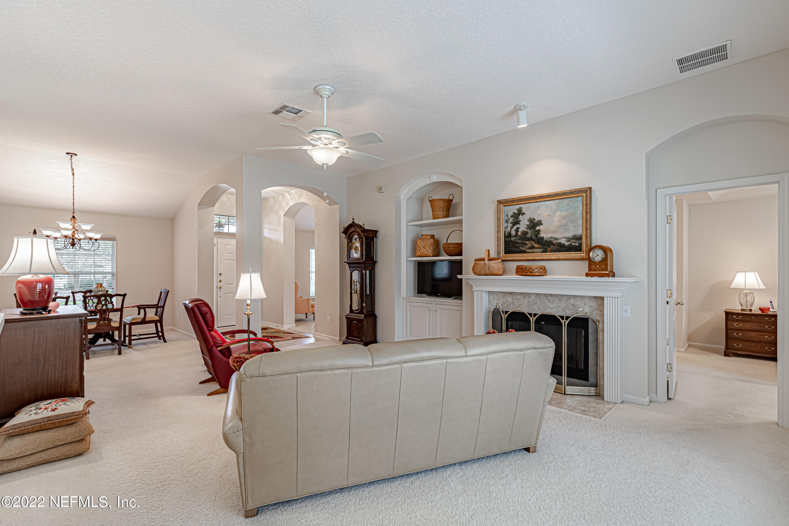 124 Dragonfly Drive Jacksonville, FL 32259 - Photo 15 of 40 a living room with furniture a fireplace and a chandelier