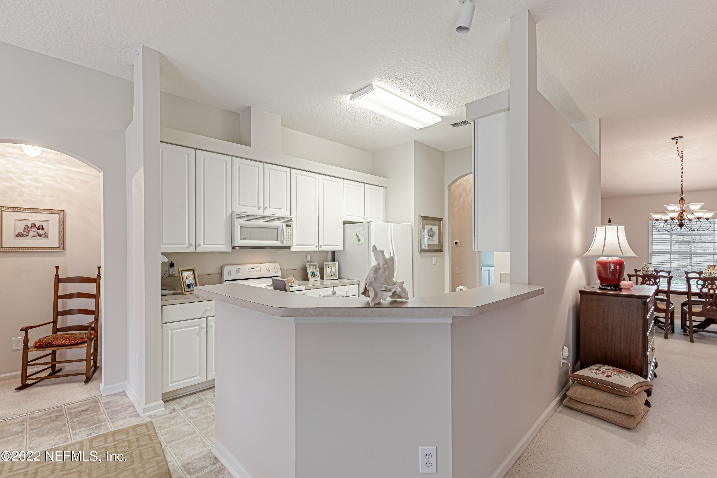 124 Dragonfly Drive Jacksonville, FL 32259 - Photo 16 of 40 a kitchen with kitchen island a sink stove and cabinets